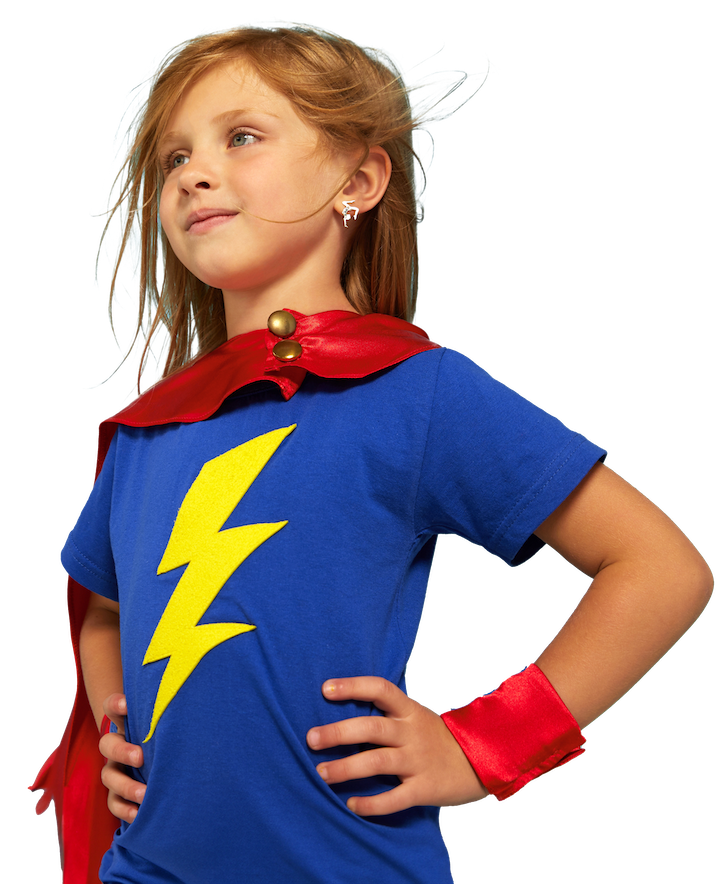 Young child wearing a blue superhero costume with a yellow lightning bolt, red cape, and wristband, looking confident